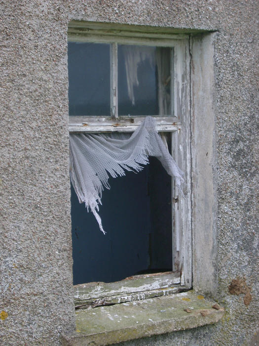 a abandoned croft building with broken windows in the outer bebrides, scotland