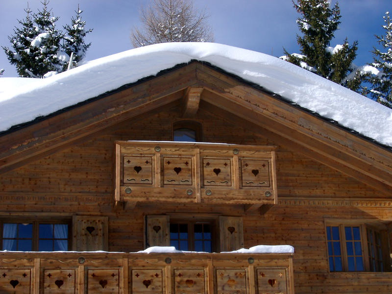 a snow covered winter mountain cabin, france