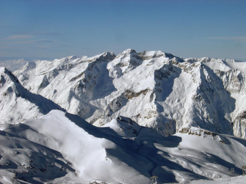 an alpine scene, snow covered mountains in france