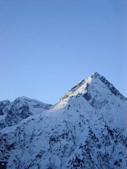 an alpine scene, snow covered mountains in france