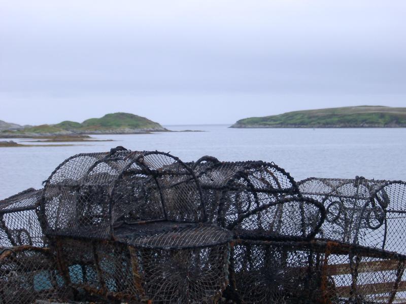 a pile of crap pots on the side of a scottish loch, fishing and netting
