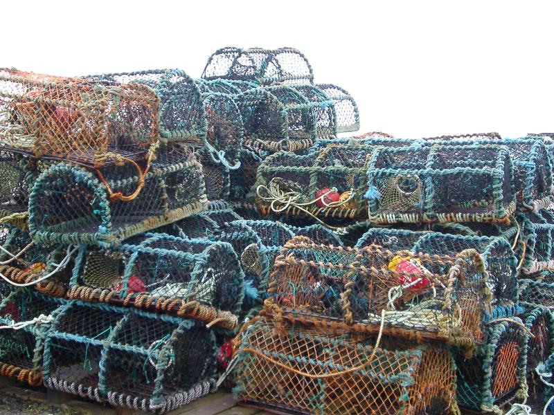 a pile of crap pots on the side of a scottish loch, fishing and netting