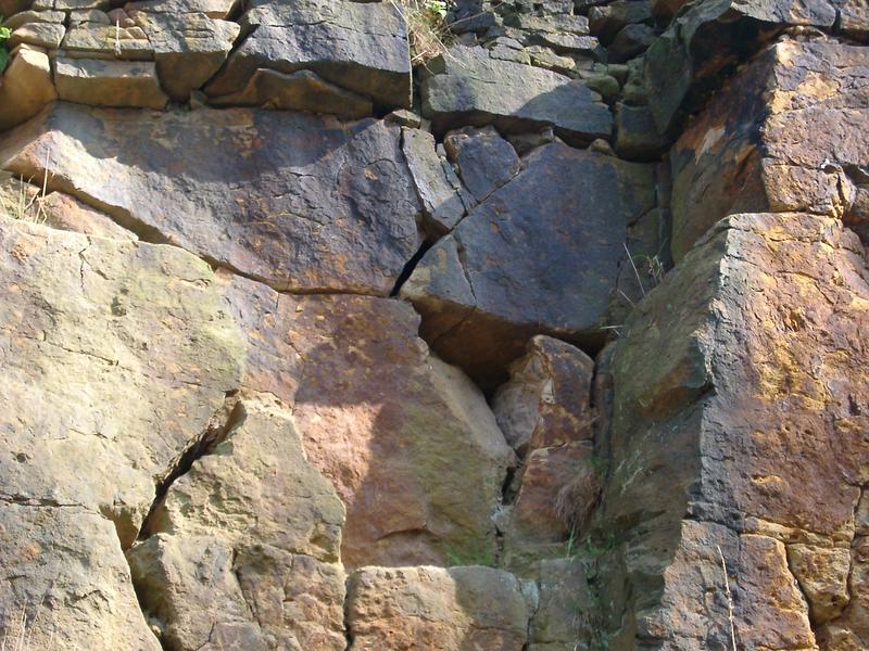 close up on cracks and the texture of a rock face