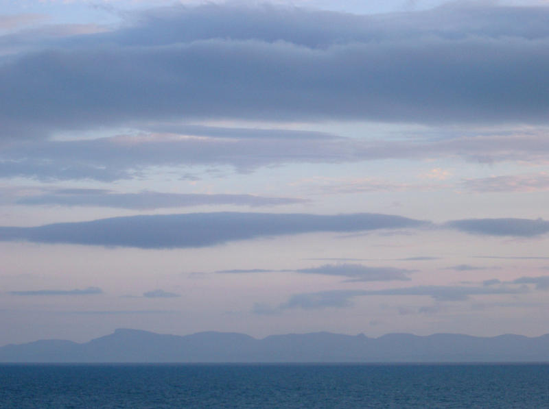 after sunset looking across the water at a distant landmass