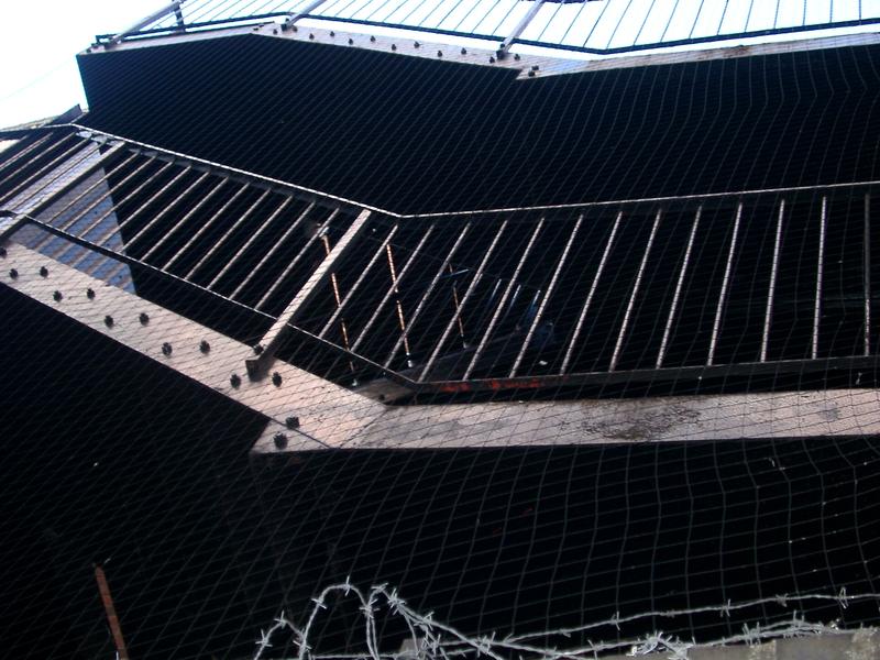 abstract angle photo of a rusty old fire escape stairs