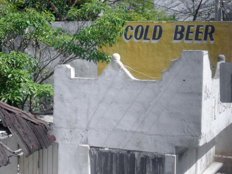 a building in mexico with a sign cold beer