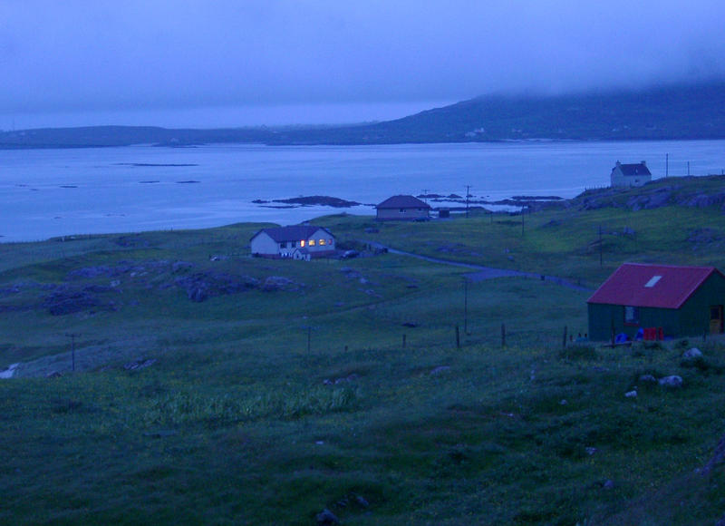 a nightscape in the scottish islands, and small house overlooking the bay