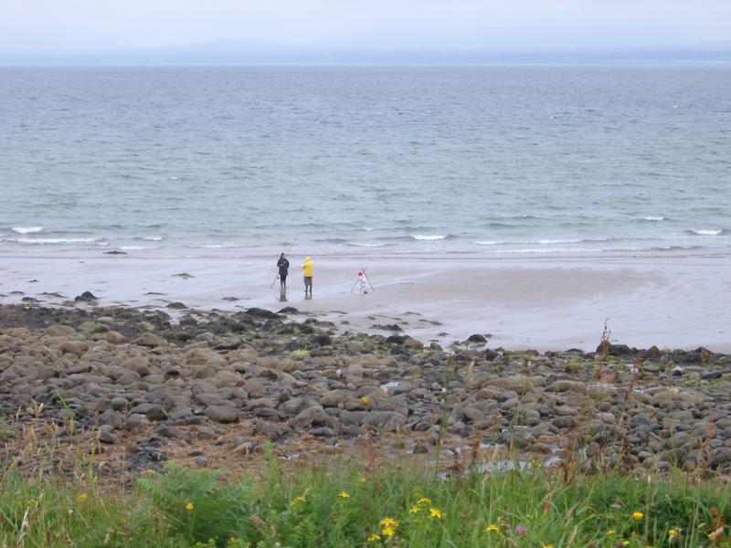 two fishermen on the beach, shell island, north wales, uk