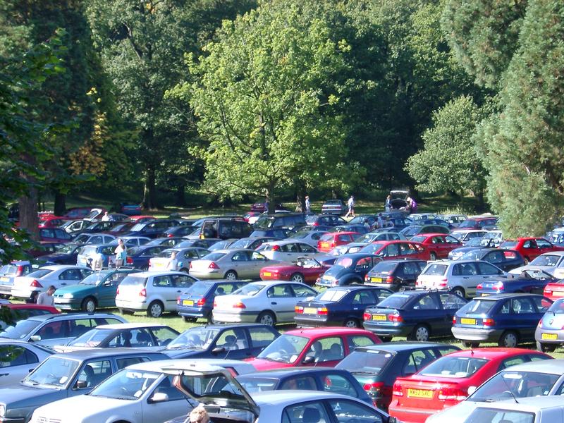 cars parked in a field for an outdoor event