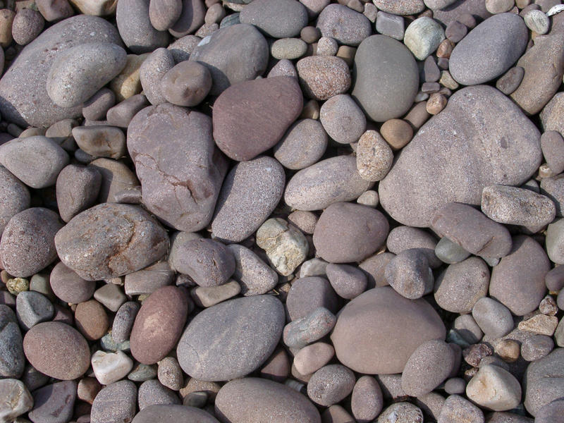 background of rounded pebbles on the sea shore