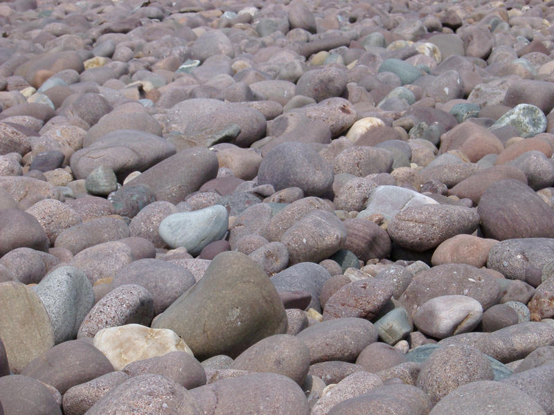 background of rounded pebbles on the sea shore