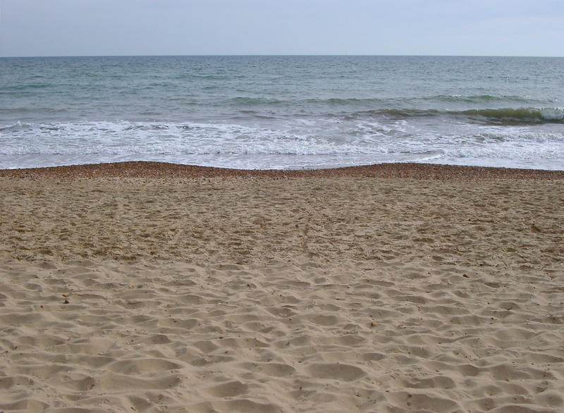 waves lapping on a sandy shoreline