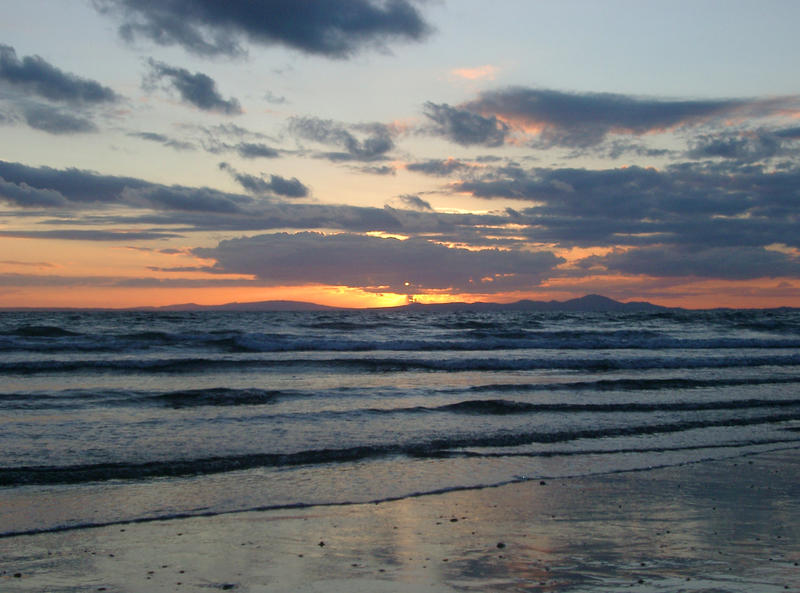 sunset over the beach at shell island, north wales