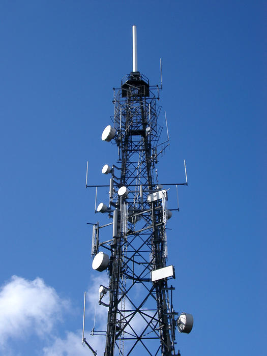 a tv transmission mast with microwave dishes