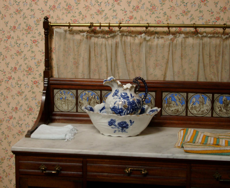 a traditional bedroom washstand with wash bown and jug