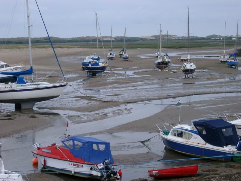 a tidal harbour full of yachts at low tide