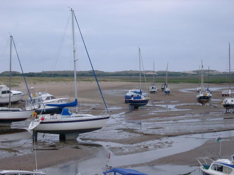 a tidal harbour full of yachts at low tide