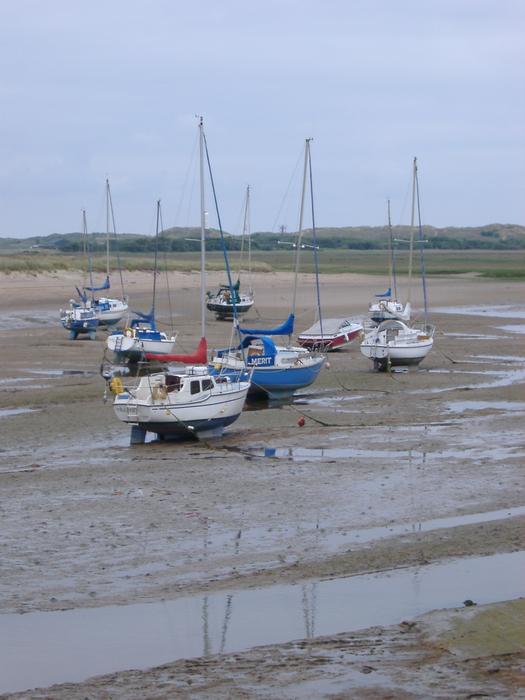 a tidal harbour full of yachts at low tide