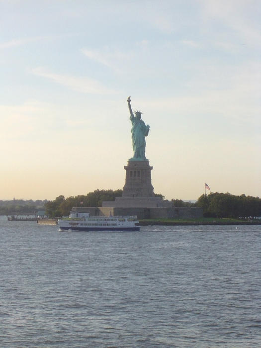 Liberty Enlightening the World standing proud at the gateway to new york city