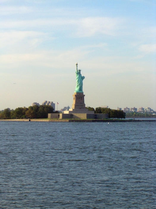 Liberty Enlightening the World standing proud at the gateway to new york city