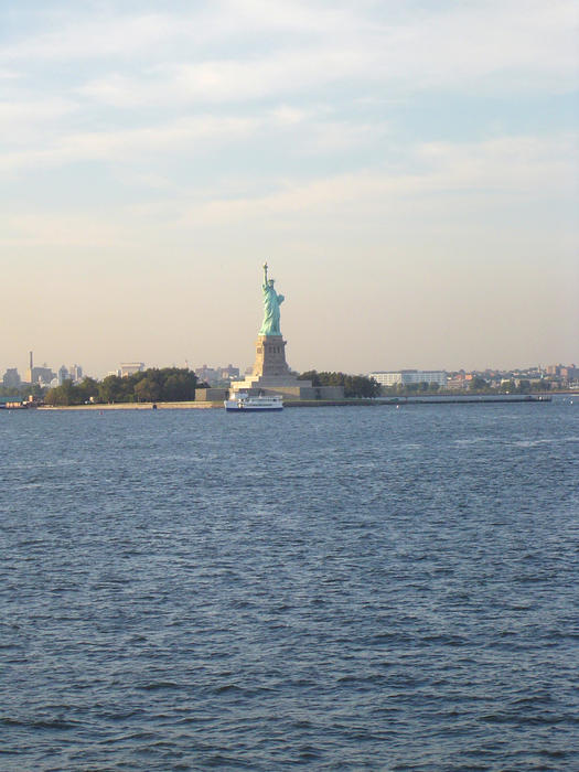 Liberty Enlightening the World standing proud at the gateway to new york city