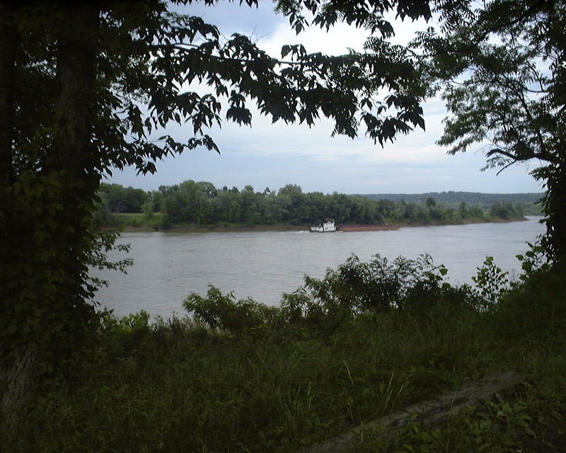 <p>Riverboats loaded with their cargo heading south on the Ohio River near Otter Creek Park, Muldraugh, Kentucky.</p>