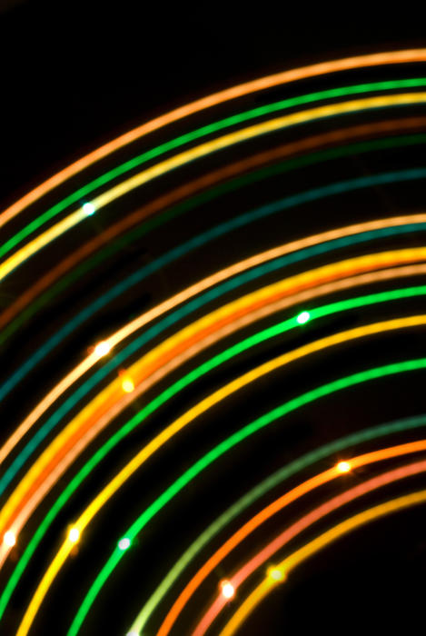 arcs of colourful light with an orange and green palette