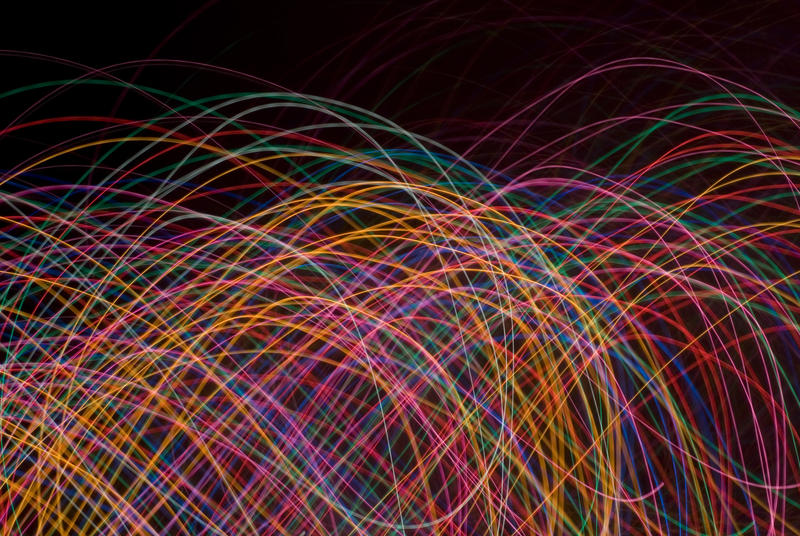 weaving and intertwined curved lines of light on a black background