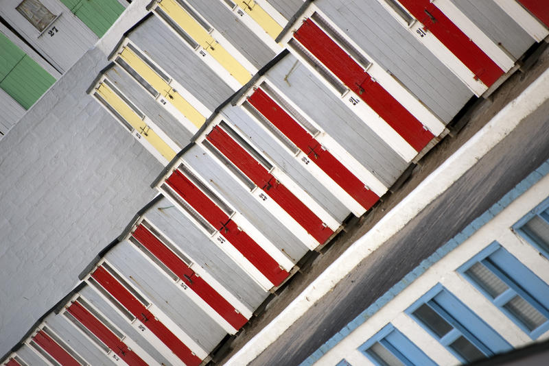 lines of colourful beach huts on Tolcarne Beach, Newquay