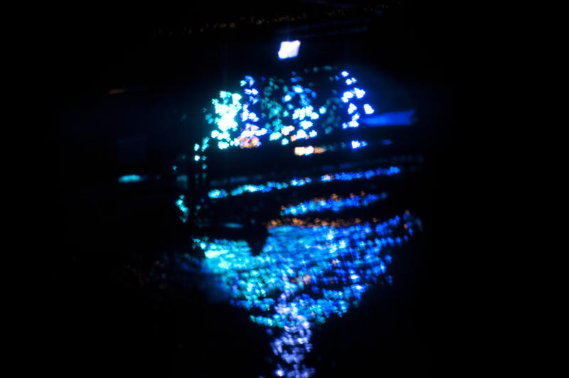 image of blue lights reflecting off the surface of water at night