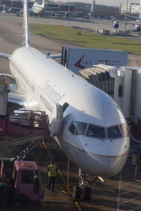 editorial use only : a jet airplane at an airport boarding bridge