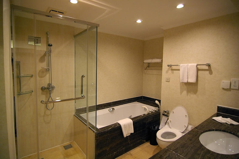 a clean modern bathroom with shower and bath, toilet and wash basin