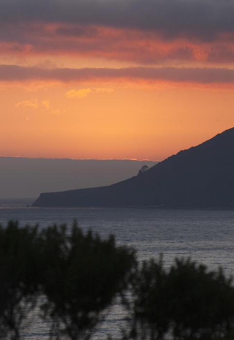 glowing orange sunset over california's spectacular big sur coastline