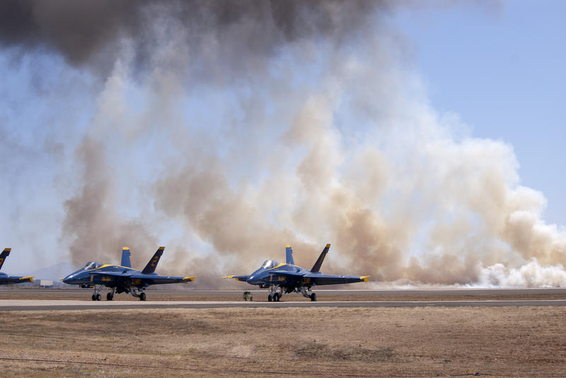 a row of navy blue angles FA 18 with a smoky 'battle scene' background
