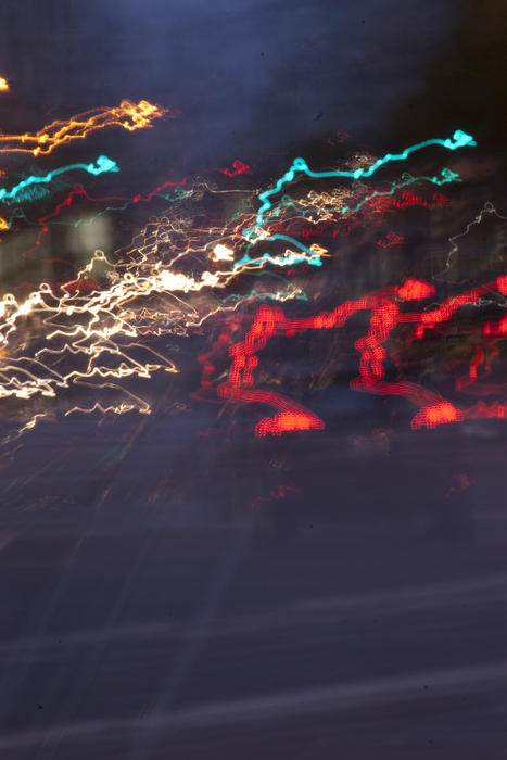 blurred lines of light from traffic moving at night on a busy city street