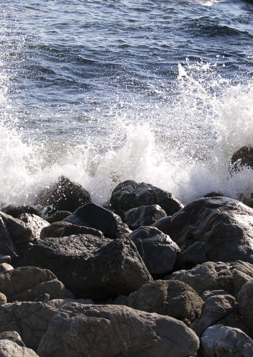 waves breaking over a man made break water