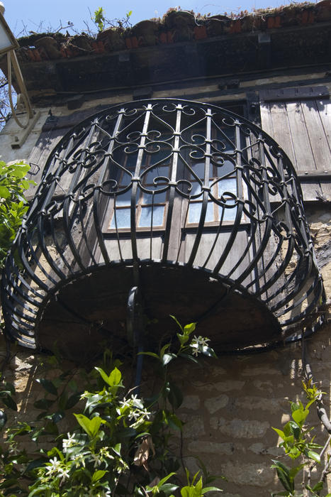 a cast iron balcony on an old french building