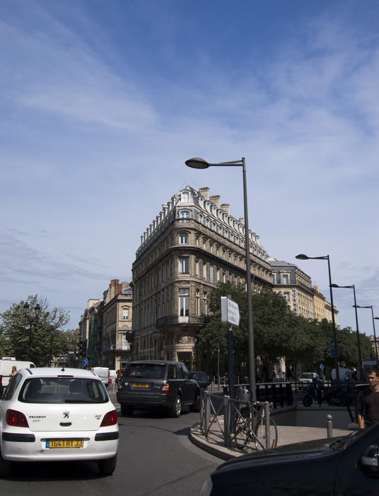 a city scene traffic and french architecture in the city of bordeaux, france