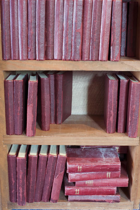 a church bookshelf full of well used hymn and prayer books