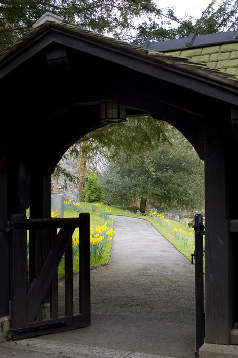 a litch gate at the entrance to a rural church