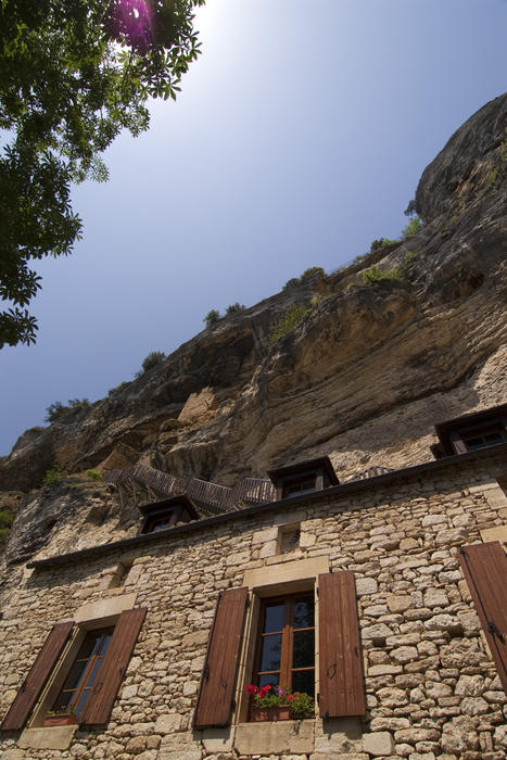 house built into the bottom of a cliff, france