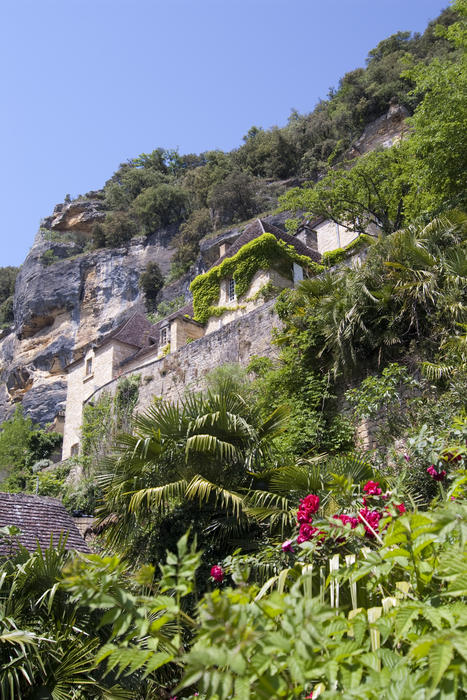 a house built into cliff terraces in france