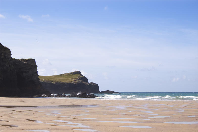 looking across a beach towards rocky headlands near newquay, cornwall