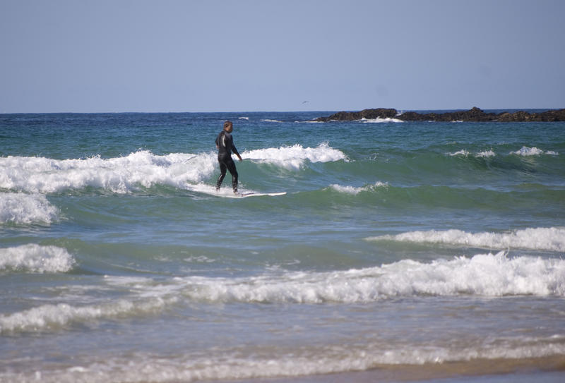 editorial use only: catching a wave, a surfer on fistral beach