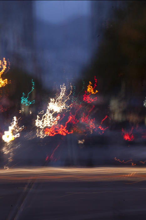 blurred lines of traffic crossing an intersection at night