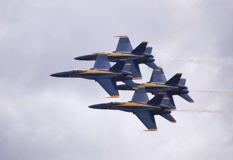 navy blue angels performing a diamond formation fly-past