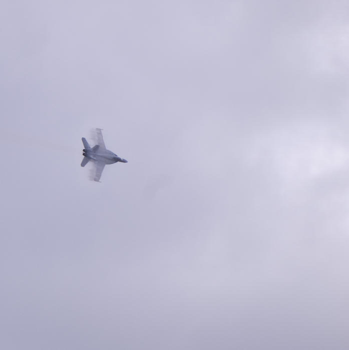 Vapour trails on the trailing wing edges of a Super Hornet FA18  aircraft