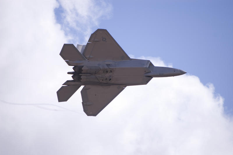 Trails of vapour from the wing of a F-22 Raptor form spirals of condenstation