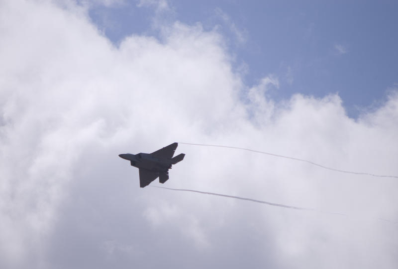 Wingtip vortices caused by a drop in pressure of air flowing over a F-22 Raptors wings in flight