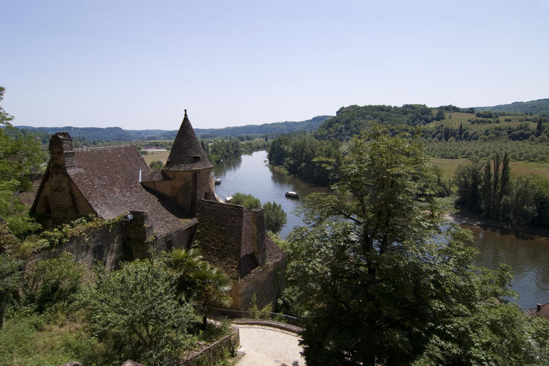 an old french chateau stood on the banks of an slow moving river